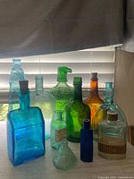 Group shot of all eleven colored glass bottles