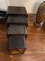 Stacked view of four nesting tables showing different sizes