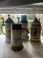 Group shot of four beer steins on table