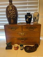 All items arranged on and in front of chest