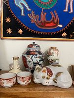 Group view of all six porcelain items on shelf
