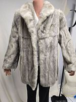 Front view of grey mink fur coat on mannequin