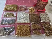 Overall view: chain spool and twelve bags of assorted metal findings