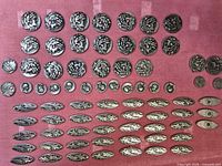 Overall view of entire button collection laid out on pink background