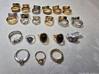 All 18 rings laid out in four rows