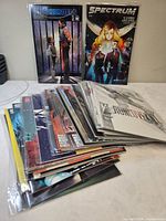Front view showing two bagged comics standing and stack of additional issues