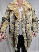 Front view of full coyote fur coat on mannequin