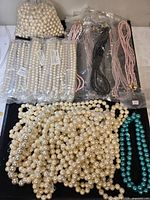 Overview of all faux pearl beads including bag, sealed sleeves and loose strands