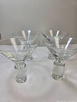 All four crystal martini glasses upright showing overall design