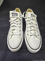 Top view of both sneakers showing laces, tongues and toe caps