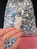Full bag of blue glass stones with label visible