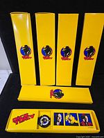 Multiple yellow Dick Tracy boxes and one opened tray showing watch set