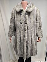 Front view of grey fur coat showing buttons and collar