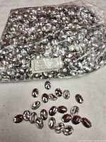 Full bag of rhinestones with some spread out to show shape and size