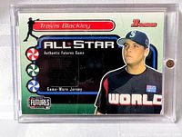 Front view of card showing jersey swatch window and player image in screw-down case