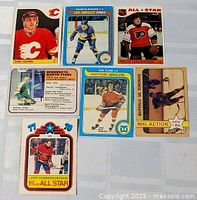 Seven hockey cards laid out showing fronts