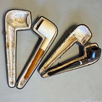 Both open cases showing interiors and pipes inserted