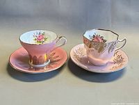 Two pink bone china teacup and saucer sets side by side