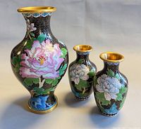 Front view showing all three vases, floral design and relative sizes