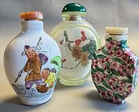 Front view of all three snuff bottles showing designs and shapes