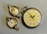 Front view of three watches showing dials and case styles