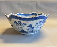 side view of entire bowl showing exterior landscape design and scalloped rim