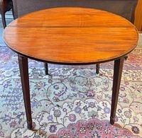 Top view of mahogany demi-lune table fully opened