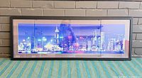 Front view of framed Hong Kong skyline print showing image, frame, and mat