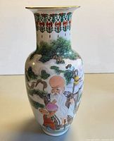 Full view of hand-painted porcelain vase with Shou Lao scene