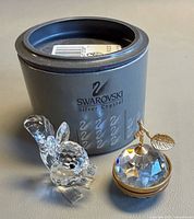 Overall lot showing Swarovski squirrel, crystal apple, and original round box