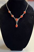 Necklace on display bust showing overall design and stone layout