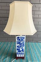 Full view of lamp unlit showing shade, porcelain body, base, cord