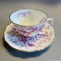 Teacup on saucer, showing interior and gilt trim