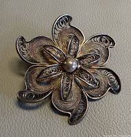 Front view of sterling filigree flower brooch