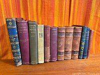 All eleven books aligned showing spines and size comparison