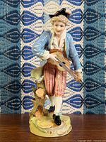 Front view of hand-painted porcelain musician figurine