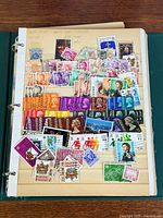 Album page densely covered with assorted Hong Kong and China stamps in various colors and sizes