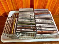 Basket containing roughly 45 classical CD jewel cases