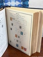 Open album showing mounted French stamps on printed pages