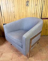 Angled view showing side metal frame, upholstery and overall chair shape