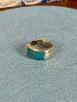 Ring front showing turquoise inlay and silver band