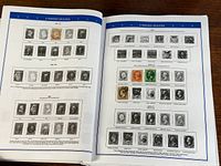 open album showing two pages of mounted U.S. stamps