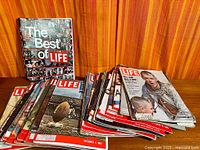 Stack of LIFE magazines and hardcover "The Best of LIFE" book front view
