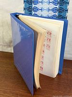 Closed blue binder album standing upright