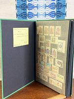Album opened showing note and first stamp page