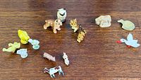Group shot of all porcelain, glass and metal miniature animals on wooden surface