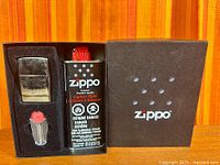 Boxed Zippo set with lighter, fluid can, flint dispenser