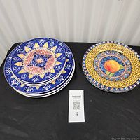 Stack of blue pattern plates and single yellow peach plate