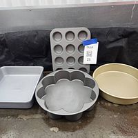 group shot of four pans: muffin tin, flower pan, round pan, square pan