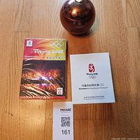 Front view of DVD, souvenir box, and tea tin